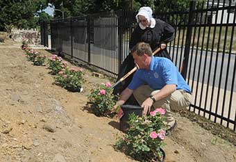 Scott Huston and Sarah Brody plant a rose