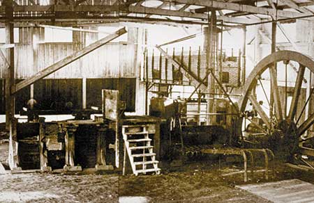 Interior photo of the Brandywine Iron Works taken about 1870. The water-powered flywheel turned the rolls of the mill.