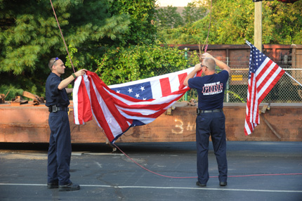 Coatesville firemen prepare to raise the flag