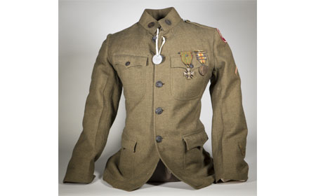 Uniform Coat, Dog Tag, Croix de Guerre, and Victory Medal with 3 Battle Zone Bar Pins — Like Stewart Huston, Fred Strickland was a U.S. Army ambulance driver with the French Army. Stewart would have worn a uniform similar to this. The Croix de Guerre (Cross of War) was a French Military decoration awarded to foreign military forces allied to France. French military officials created it after World War I when they felt a need to honor acts of heroism by non-French forces during combat in the war. It could have been awarded to a unit or to an individual for distinguished service. Fred Strickland and Stewart Huston were both awarded this medal for thier actions as ambulance drivers with the French Army. — Courtesy of Bob Ford